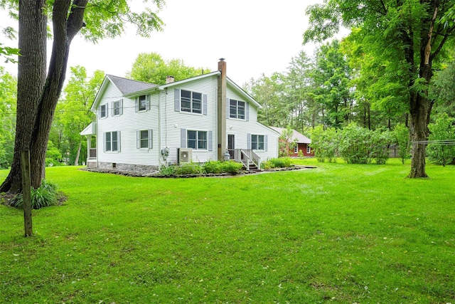591 Hillside Lake Rd, Wappingers Falls, NY 12590 - back of property featuring a chimney and a lawn