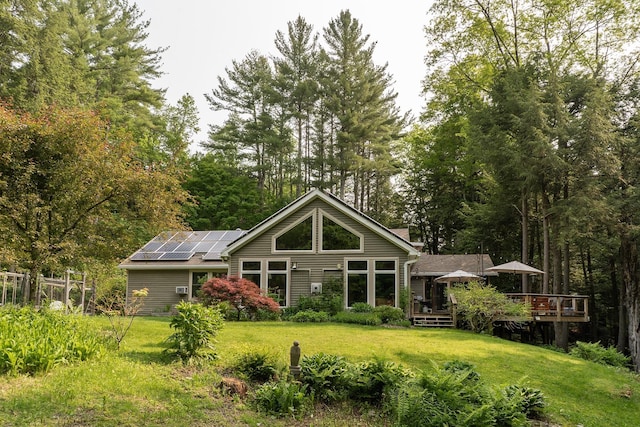 70 Reardon York Est, Canaan, NY 12029 - back of property with roof mounted solar panels, a lawn, and a deck