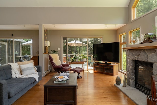 70 Reardon York Est, Canaan, NY 12029 - living area with a fireplace, a baseboard heating unit, and light wood-style flooring