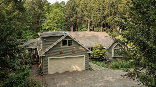 70 Reardon York Est, Canaan, NY 12029 - view of front of house with driveway, a wooded view, and roof with shingles