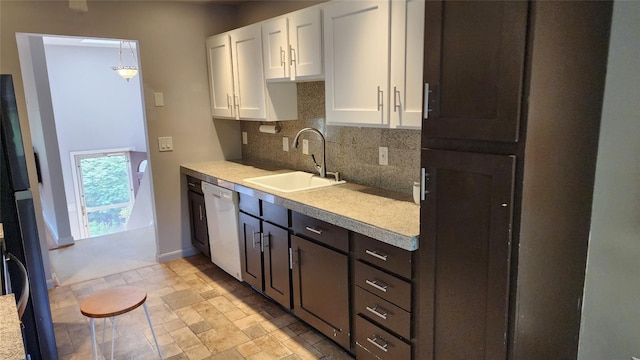663 N Dunton Ave, East Patchogue, NY 11772 - kitchen featuring dishwasher, white cabinets, decorative backsplash, light countertops, and light stone finish floors
