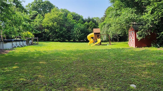 663 N Dunton Ave, East Patchogue, NY 11772 - view of green lawn featuring a storage unit, a covered pool, and a playground