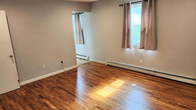 663 N Dunton Ave, East Patchogue, NY 11772 - empty room featuring a baseboard radiator and wood finished floors