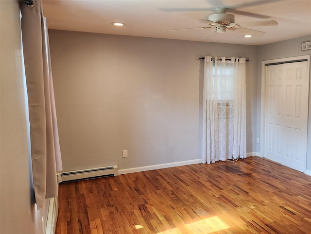 663 N Dunton Ave, East Patchogue, NY 11772 - unfurnished bedroom featuring a baseboard heating unit, wood finished floors, recessed lighting, ceiling fan, and a closet