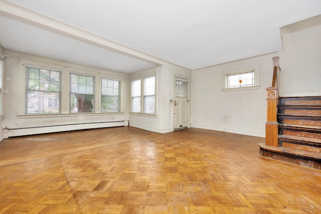 88-11 79th Ave, Glendale, NY 11385 - unfurnished living room featuring a baseboard radiator and stairway