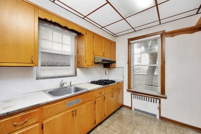 88-11 79th Ave, Glendale, NY 11385 - kitchen featuring radiator, black gas stovetop, light countertops, and under cabinet range hood