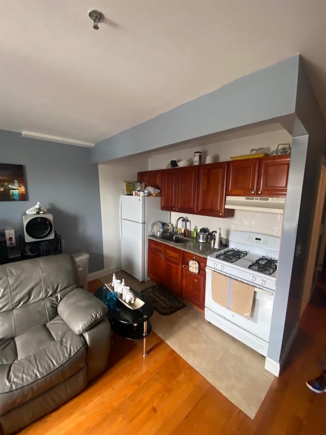 1459 Rosedale Ave, Bronx, NY 10460 - kitchen featuring white appliances, under cabinet range hood, and light wood-style flooring