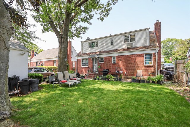 33 Cherry Ln, Carle Place, NY 11514 - rear view of house featuring a chimney, brick siding, and entry steps
