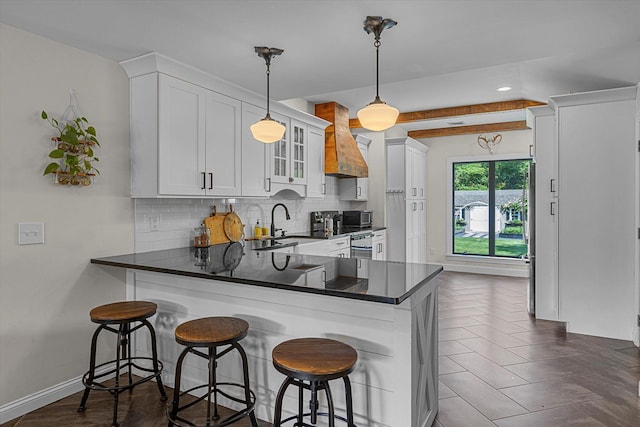 135 Vanderbilt Blvd, Oakdale, NY 11769 - kitchen featuring premium range hood, tasteful backsplash, white cabinets, and recessed lighting
