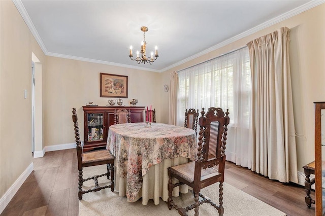 19 Salisbury Dr N, East Northport, NY 11731 - dining space featuring a chandelier, wood finished floors, and ornamental molding
