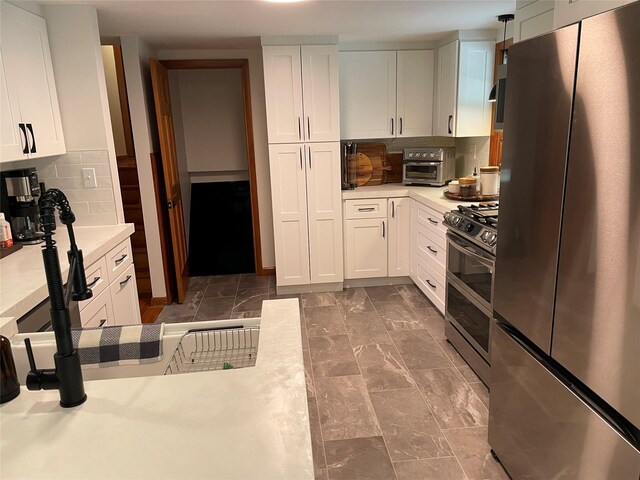 1289 State Route 208, Wallkill, NY 12589 - kitchen with stainless steel appliances, light countertops, white cabinets, tasteful backsplash, and dark marble finish flooring