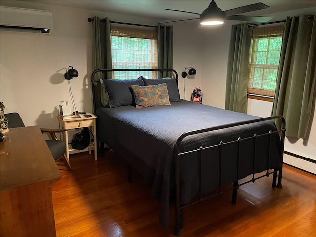 1289 State Route 208, Wallkill, NY 12589 - bedroom with an AC wall unit, wood finished floors, and a baseboard heating unit