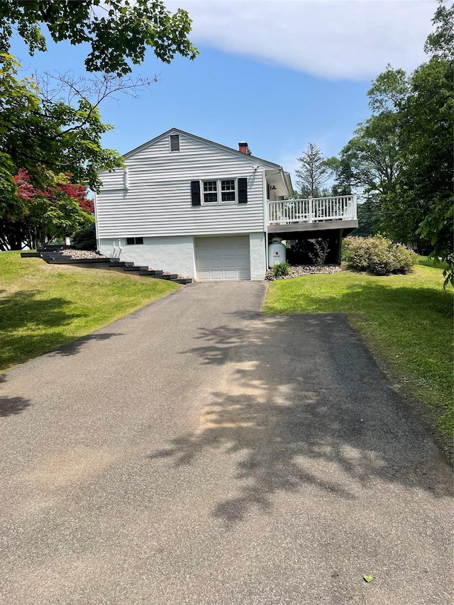 1289 State Route 208, Wallkill, NY 12589 - view of front of property featuring driveway, a wooden deck, an attached garage, a front lawn, and a chimney