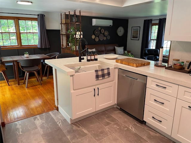 1289 State Route 208, Wallkill, NY 12589 - kitchen featuring stainless steel dishwasher, light countertops, white cabinetry, and an AC wall unit