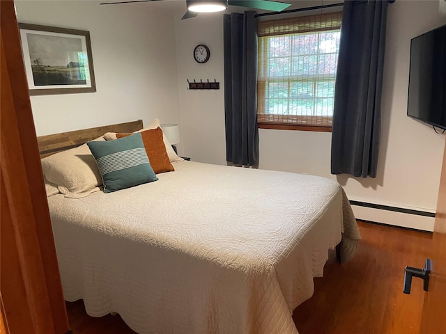 1289 State Route 208, Wallkill, NY 12589 - bedroom featuring a baseboard heating unit, wood finished floors, and ceiling fan