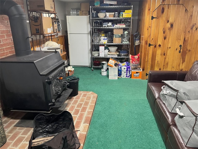 1289 State Route 208, Wallkill, NY 12589 - below grade area with freestanding refrigerator, a wood stove, and carpet flooring