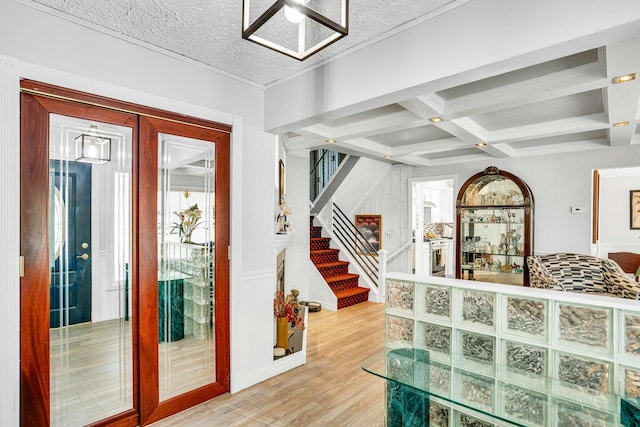 20 Wiltshire Dr, Commack, NY 11725 - entryway featuring light wood finished floors, plenty of natural light, stairs, coffered ceiling, and beam ceiling