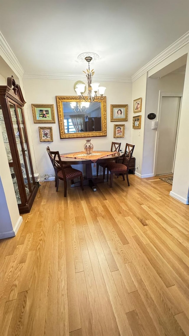99-05 63rd Dr Unit 11Aa, Rego Park, NY 11374 - dining space with a chandelier, light wood-style floors, and crown molding