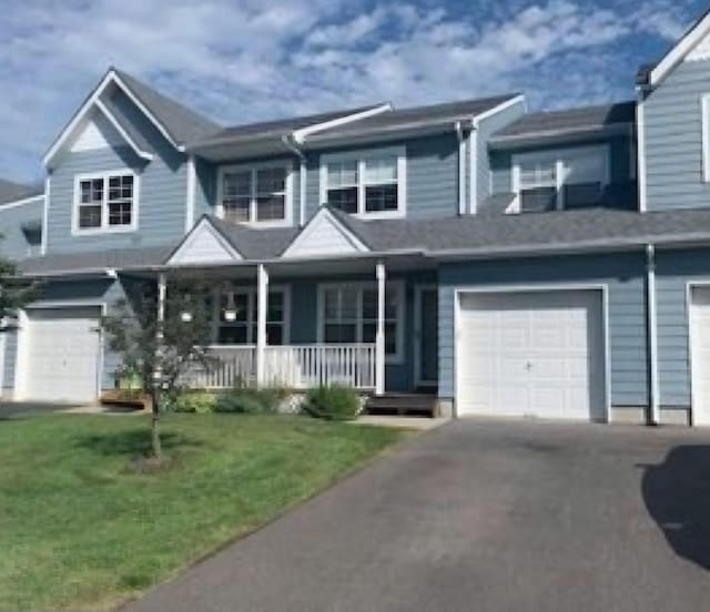 7 Shady Ln Unit 1, Central Islip, NY 11722 - multi unit property with covered porch, driveway, a front yard, and a garage