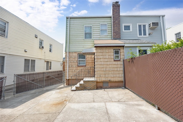 6438 60th Rd, Maspeth, NY 11378 - back of house featuring a chimney and a patio area