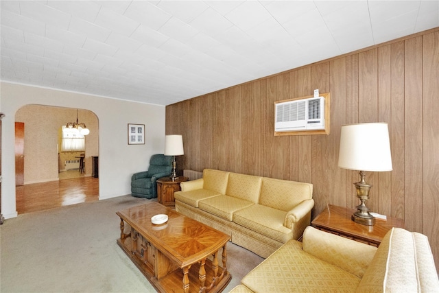 6438 60th Rd, Maspeth, NY 11378 - living area featuring arched walkways, wooden walls, and carpet