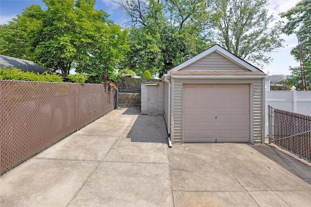 6438 60th Rd, Maspeth, NY 11378 - detached garage featuring concrete driveway