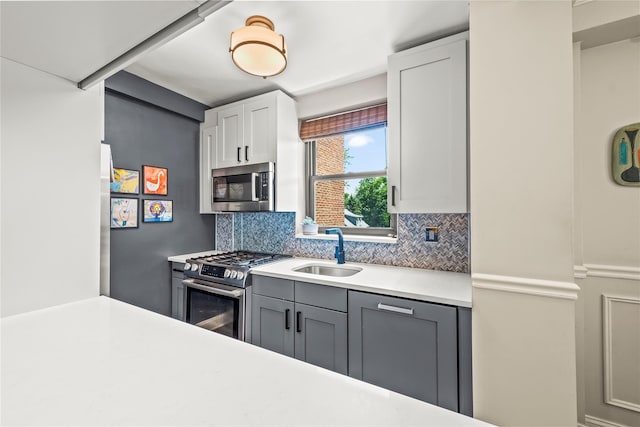 3103 Fairfield Ave Unit 4A, Bronx, NY 10463 - kitchen featuring appliances with stainless steel finishes, decorative backsplash, light countertops, and white cabinets