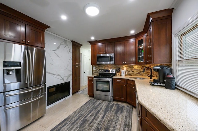 27 The Plains Rd, Levittown, NY 11756 - kitchen featuring appliances with stainless steel finishes, recessed lighting, glass insert cabinets, light stone countertops, and dark brown cabinetry
