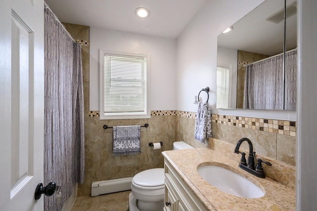 27 The Plains Rd, Levittown, NY 11756 - full bath with a baseboard heating unit, tile walls, tile patterned floors, vanity, and curtained shower