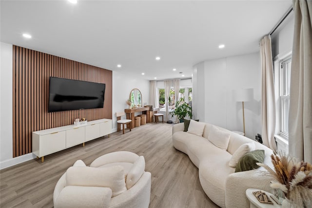 3234 204th St, Bayside, NY 11361 - living room with recessed lighting, light wood finished floors, and an accent wall