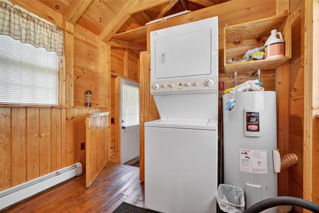 4 Debbie Ct, Chester, NY 10918 - washroom featuring a baseboard radiator, stacked washer / drying machine, wood walls, electric water heater, and hardwood / wood-style flooring