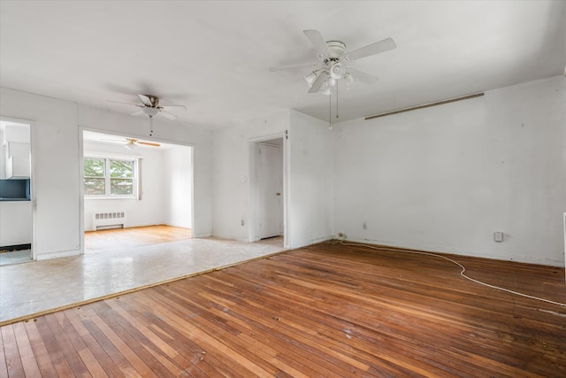 81-29 156th Ave Unit 4, Howard Beach, NY 11414 - spare room with radiator heating unit, ceiling fan, and hardwood / wood-style floors