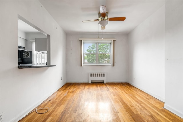 81-29 156th Ave Unit 4, Howard Beach, NY 11414 - empty room featuring radiator, a ceiling fan, and hardwood / wood-style floors