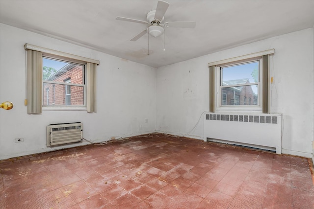81-29 156th Ave Unit 4, Howard Beach, NY 11414 - empty room with radiator heating unit, a wall unit AC, a ceiling fan, and tile patterned floors