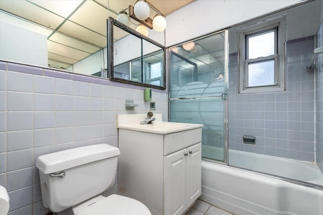 81-29 156th Ave Unit 4, Howard Beach, NY 11414 - full bath with tile walls, vanity, combined bath / shower with glass door, and tile patterned floors