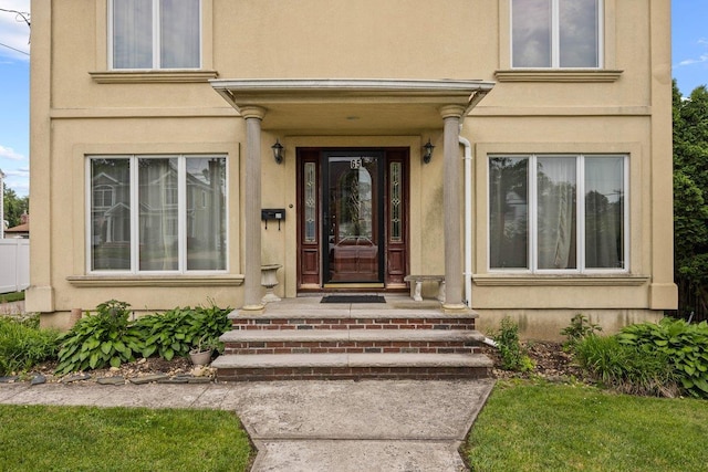 65 Netherwood Dr, Albertson, NY 11507 - entrance to property featuring stucco siding