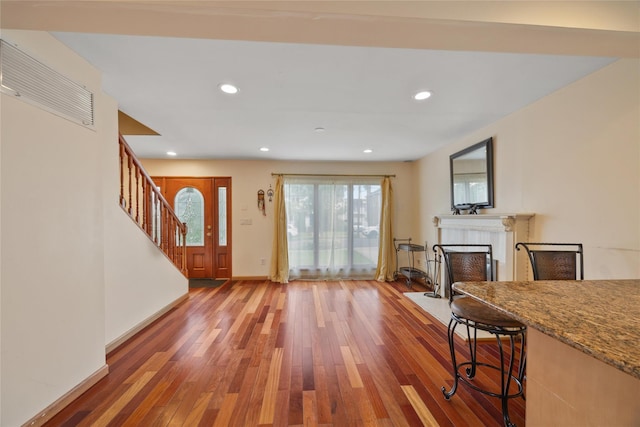 65 Netherwood Dr, Albertson, NY 11507 - entrance foyer with hardwood / wood-style flooring, stairs, a fireplace with flush hearth, and recessed lighting