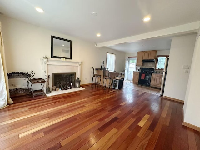 65 Netherwood Dr, Albertson, NY 11507 - living area featuring a fireplace with flush hearth, wood finished floors, and recessed lighting