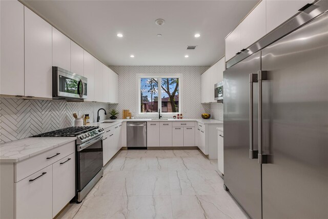 17 Union Rd Unit 208, Spring Valley, NY 10977 - kitchen featuring appliances with stainless steel finishes, light marble finish floors, recessed lighting, white cabinetry, and tasteful backsplash