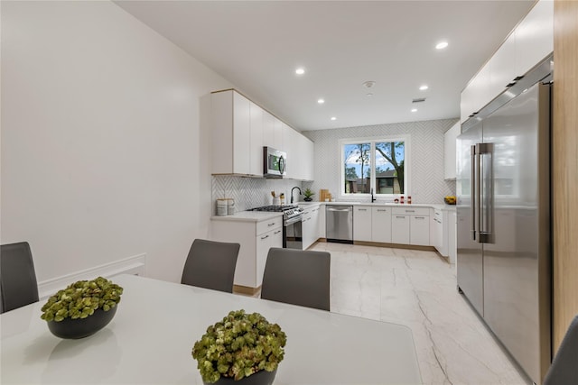 17 Union Rd Unit 208, Spring Valley, NY 10977 - kitchen with appliances with stainless steel finishes, light marble finish flooring, light countertops, recessed lighting, and white cabinetry