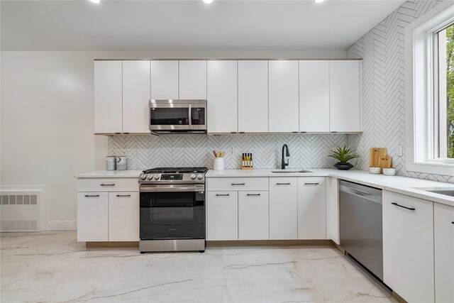 17 Union Rd Unit 208, Spring Valley, NY 10977 - kitchen with appliances with stainless steel finishes, light marble finish floors, decorative backsplash, white cabinets, and recessed lighting