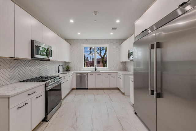 17 Union Rd Unit 208, Spring Valley, NY 10977 - kitchen featuring appliances with stainless steel finishes, light marble finish floors, recessed lighting, light stone countertops, and white cabinets