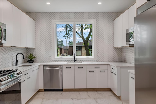 17 Union Rd Unit 208, Spring Valley, NY 10977 - kitchen with appliances with stainless steel finishes, light marble finish flooring, backsplash, recessed lighting, and white cabinets