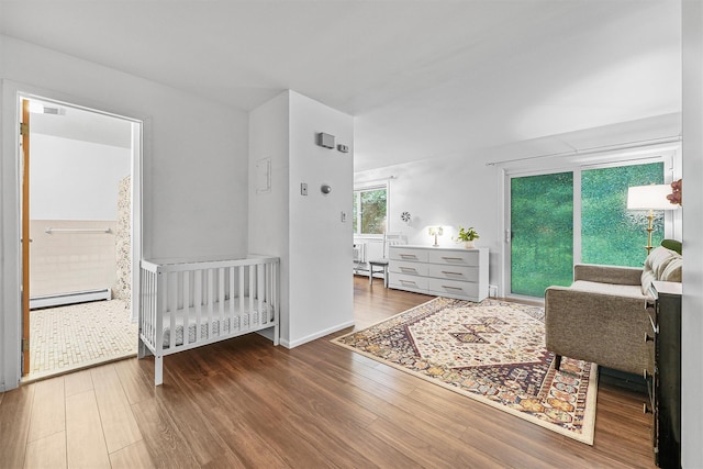 13 Scenic Dr Unit M, Croton-On-Hudson, NY 10520 - bedroom featuring wood finished floors and a baseboard heating unit