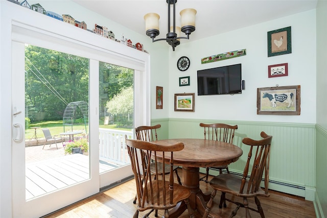 4 Tower Rd, Hopewell Junction, NY 12533 - dining area with a chandelier, a baseboard heating unit, a wainscoted wall, and wood finished floors
