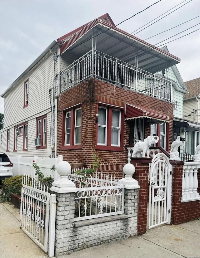 8620 130th St, Richmond Hill, NY 11418 - view of front of house featuring brick siding, a balcony, and cooling unit