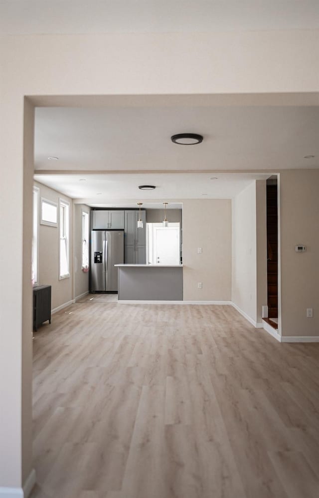 8620 130th St, Richmond Hill, NY 11418 - unfurnished living room featuring light wood finished floors and baseboards