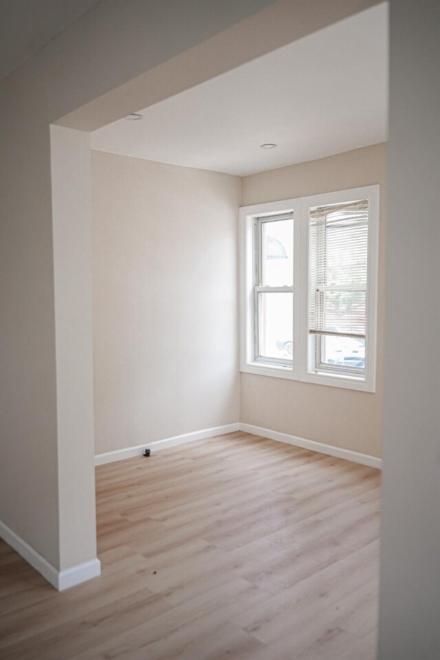 8620 130th St, Richmond Hill, NY 11418 - spare room with light wood-style floors and baseboards
