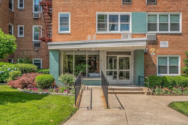 98 Dehaven Dr Unit 1F, Yonkers, NY 10703 - entrance to property with brick siding, a lawn, and cooling unit