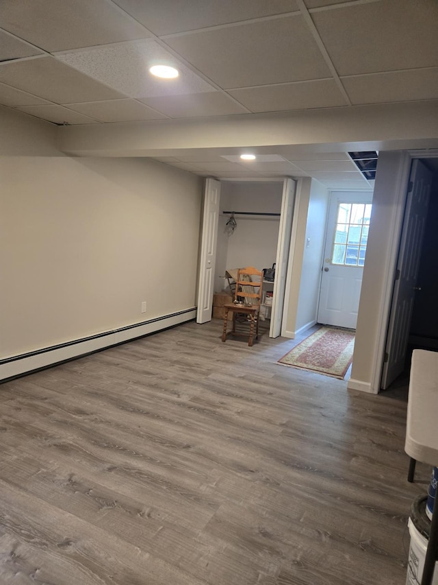 1206 August Rd, North Babylon, NY 11703 - basement with baseboard heating, wood finished floors, recessed lighting, and a drop ceiling